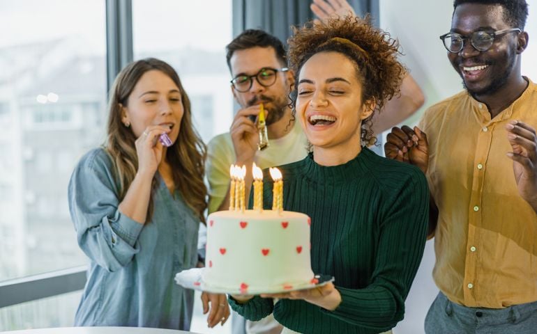 Excited young woman ready to blow out candles