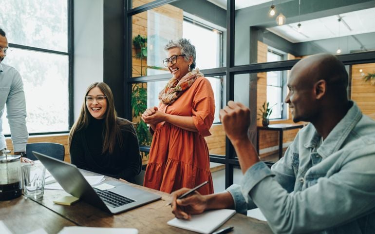Diverse businesspeople smiling cheerfully during an office meeting