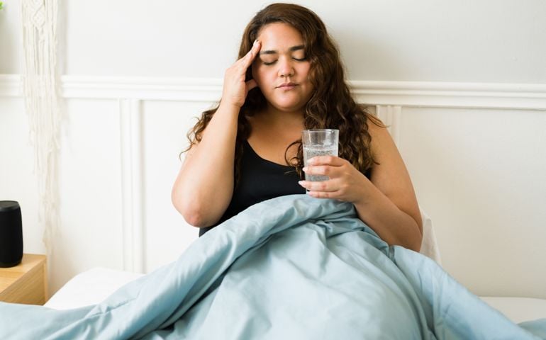 Stressed woman feeling sick because of a hangover