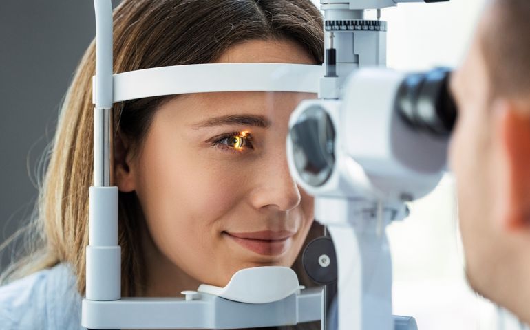 Beautiful young girl checking the eye vision in ophthalmology clinic