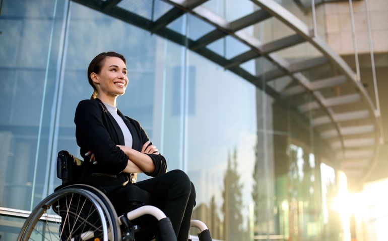 Smiling businesswoman in a wheelchair