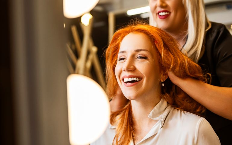 Smiling woman at hairdresser