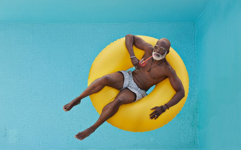 Bald man relaxing in yellow inflatable ring