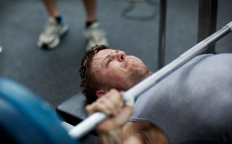 Man doing benchpress in gym