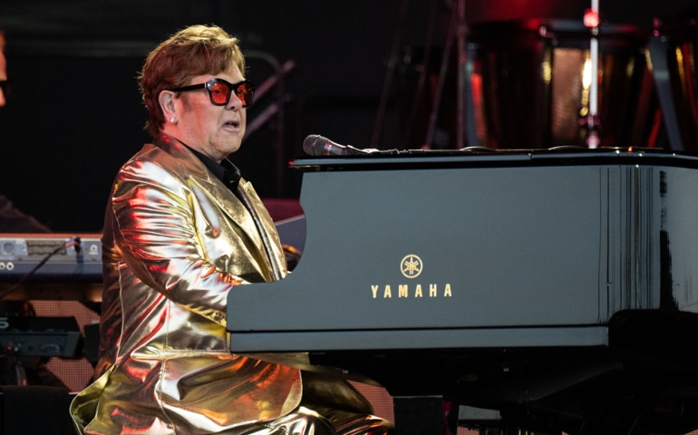 elton john playing on piano