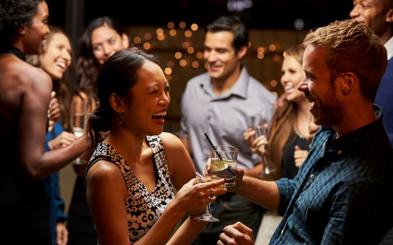 Couples Dancing And Drinking At Evening Party