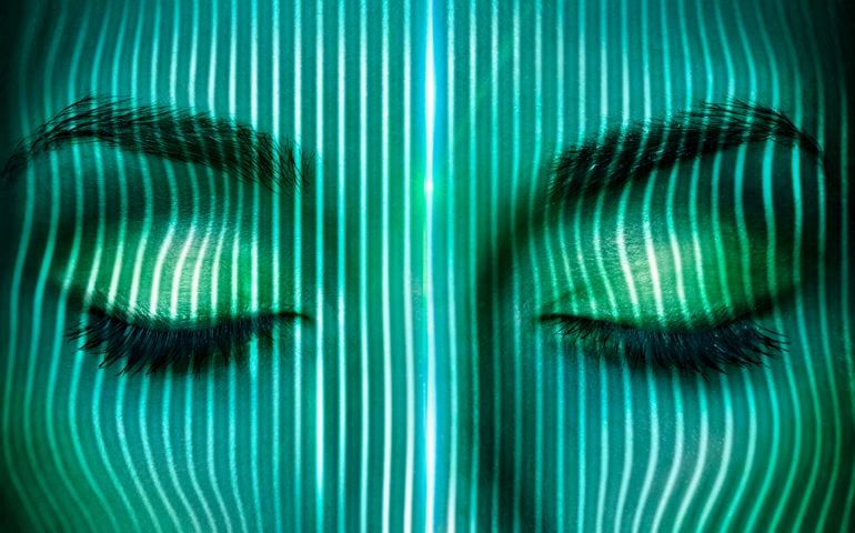 Thin laser beams going over a woman's face