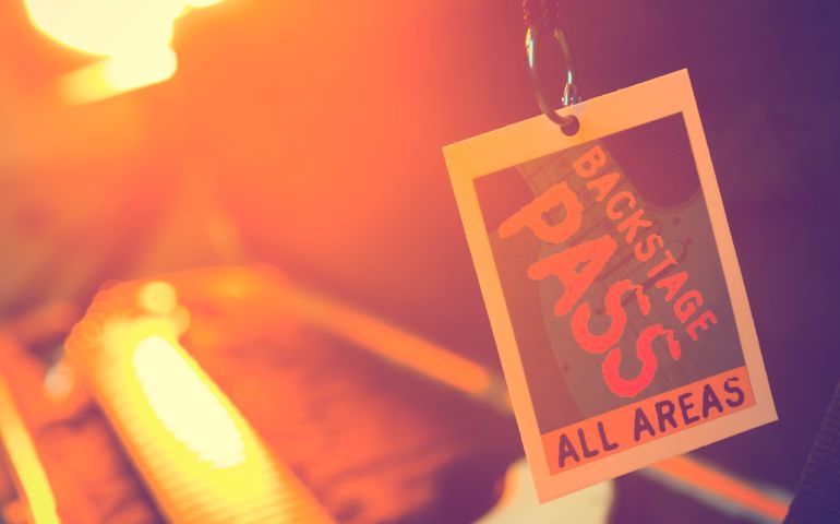 Backstage pass with a guitar.
