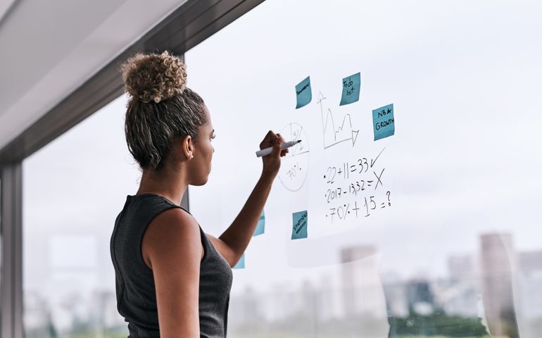 woman writing down numbers