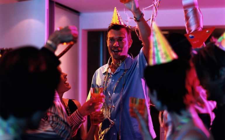 Group of people toasting at office party