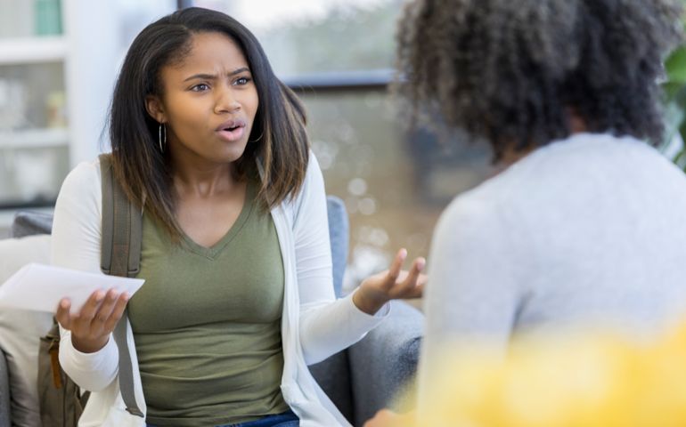 Upset teen talks with therapist
