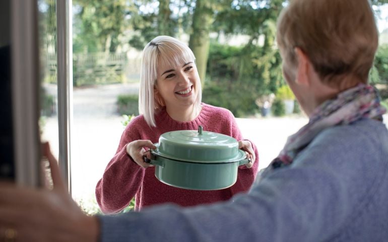 Woman Bringing Meal For Elderly Neighbour