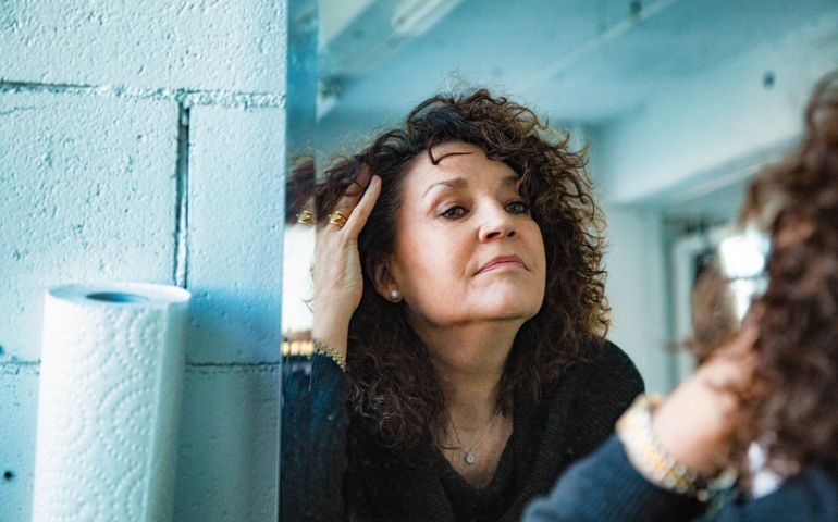 older woman looking in mirror