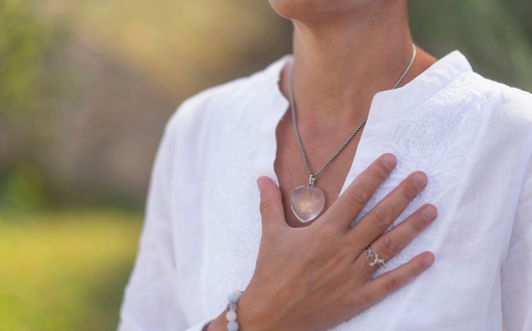 woman touching her heart