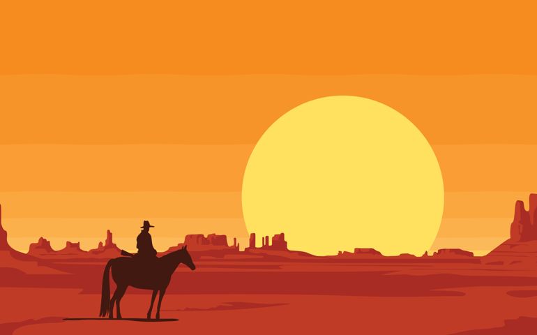 Western landscape with the silhouette of a lone rider