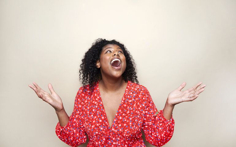 woman looking up to sky in surprise
