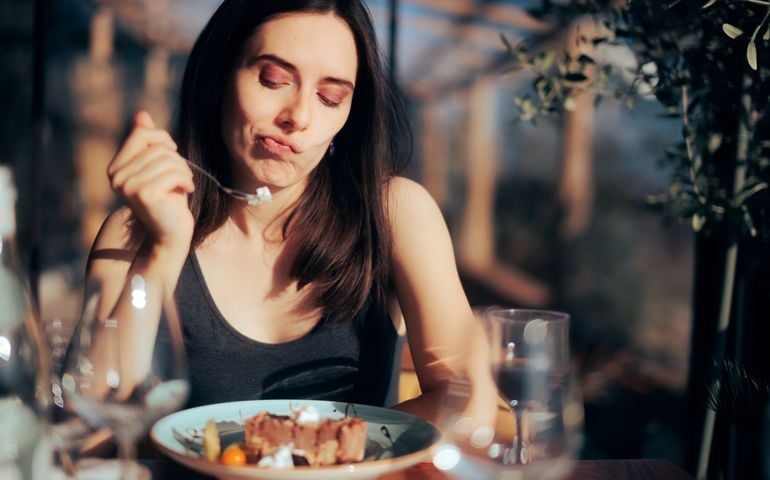Woman Unhappy with Her Dessert Eating in a Restaurant