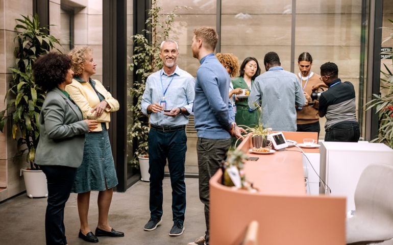 Group of business people having casual conversation while on a refreshment break