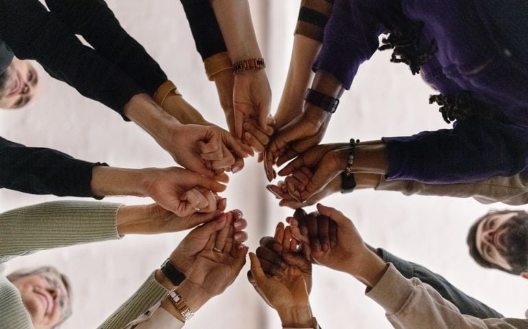 People with fist put together during support group session