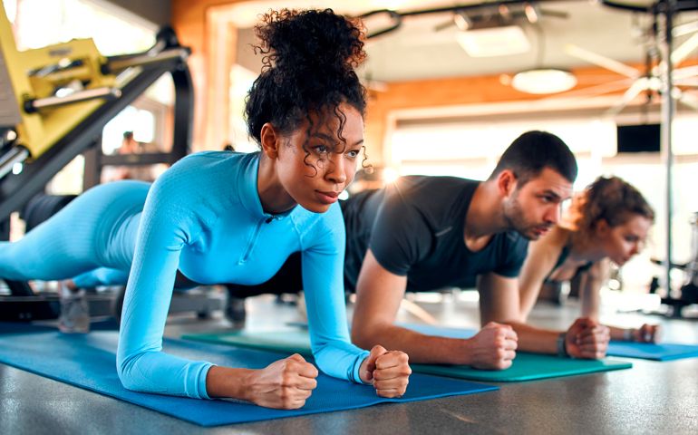 people doing a plank at the gym