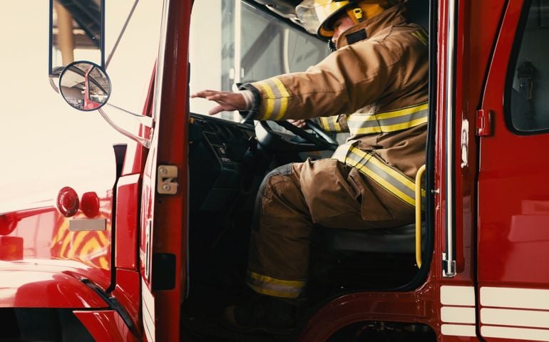 Firefighter about to close the door of his truck