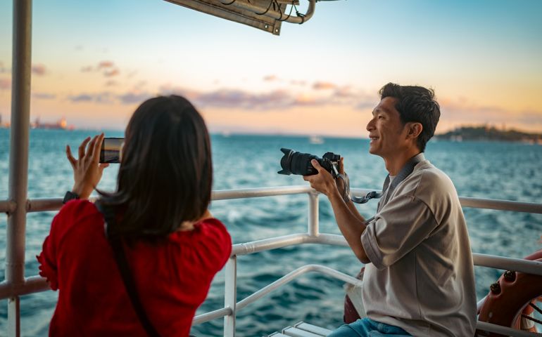 Young couple tourists taking ferry tour during their travel