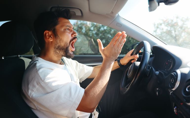 Young man getting angry on the road