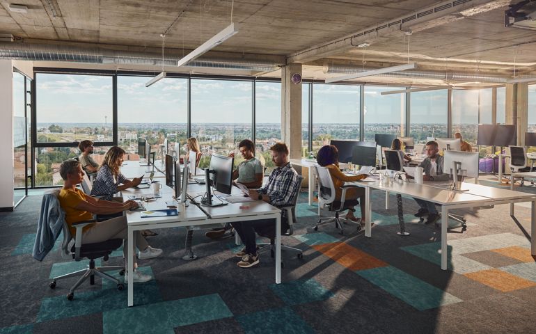 Multi-tasking computer programmers working in a modern office.