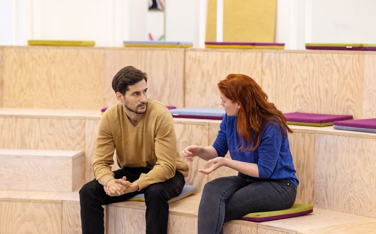 Two businesspeople discussing before a startup conference