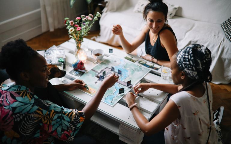 group of friends playing a boardgame at home