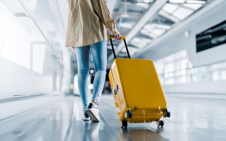 International airport terminal. Asian beautiful woman with luggage and walking in airport