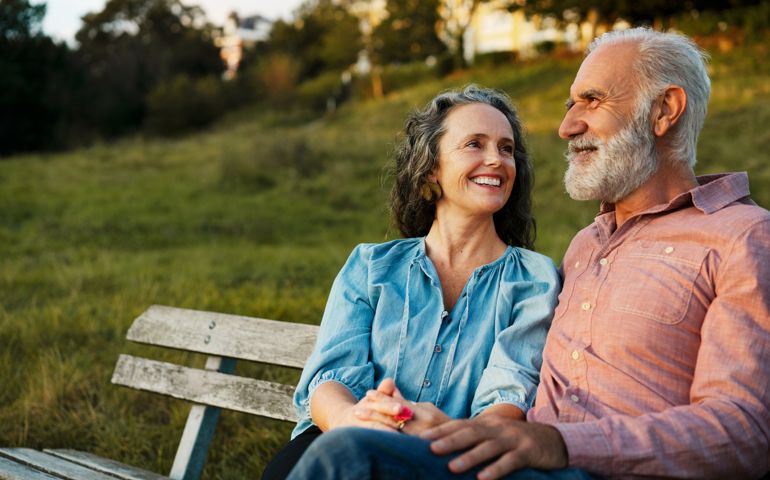 Man and woman on bench, smiling