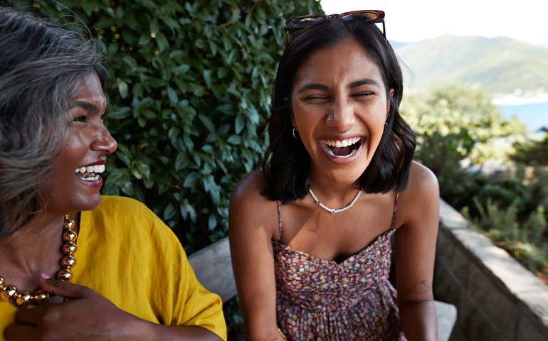 Cheerful female friends laughing together