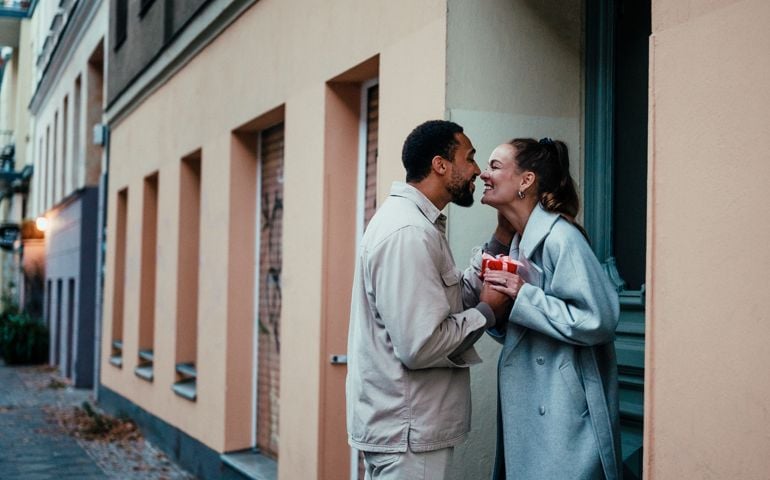 Couple with a holiday present on a doorstep