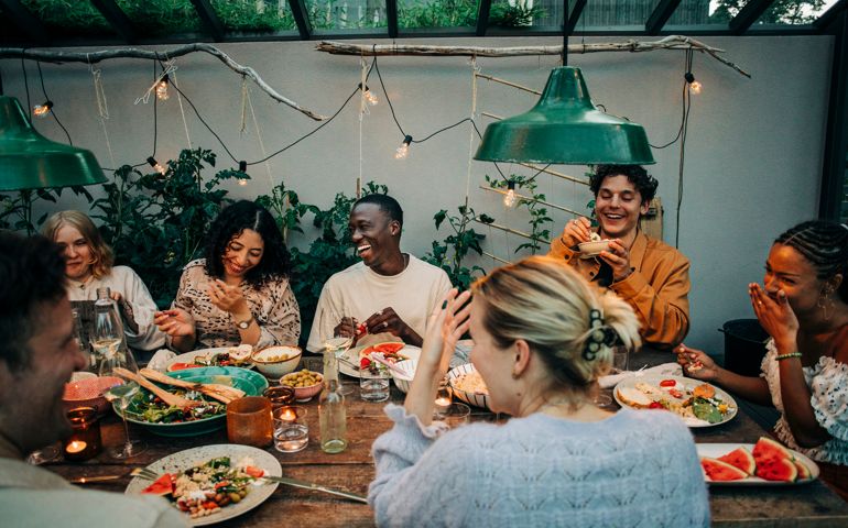 Cheerful business colleagues having dinner together in garden