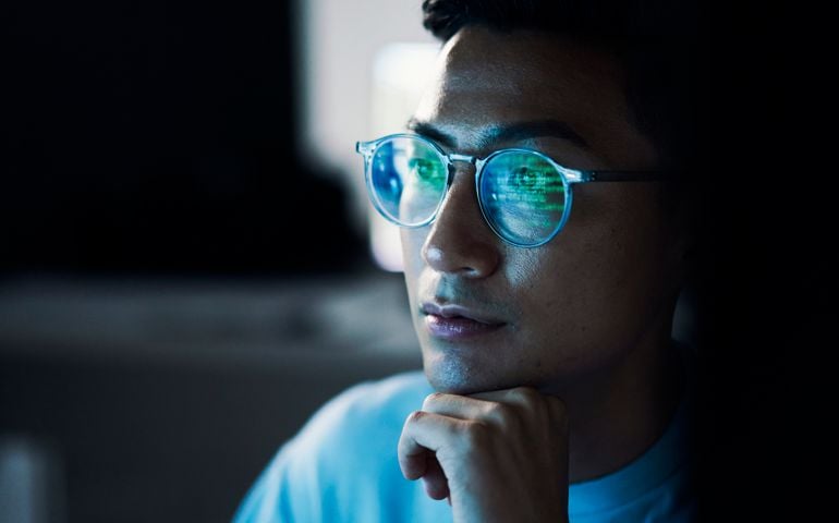man with code reflections on eyes