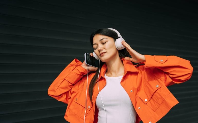woman listening to music on headphones