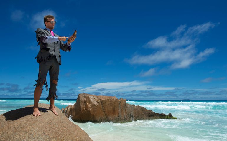 Castaway Businessman Uses Coconut Smartphone on Beach