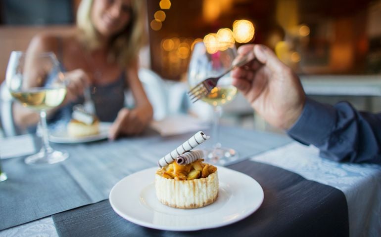 Couple eating dessert in fancy restaurant