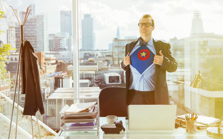 Businessman revealing superhero costume under suit