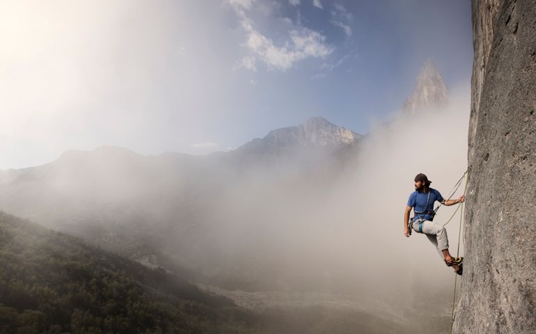 Solo Man Climbs Rock Wall
