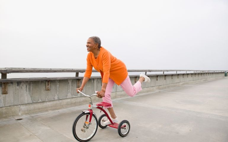 woman playing on tricycle