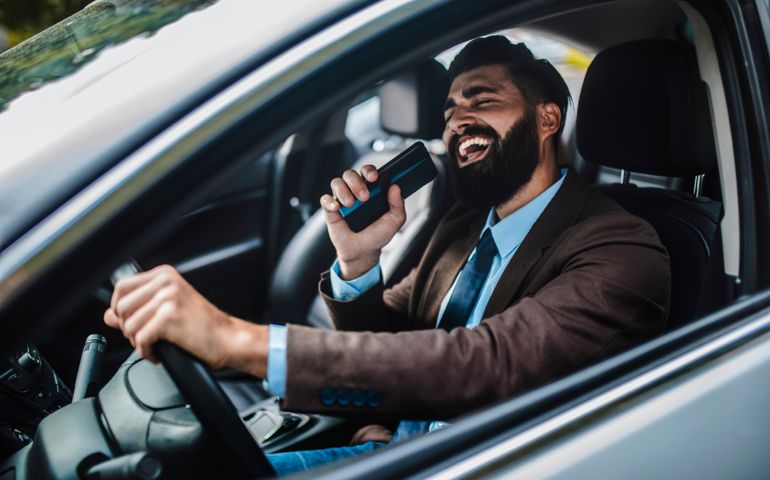 Businessman in car singing