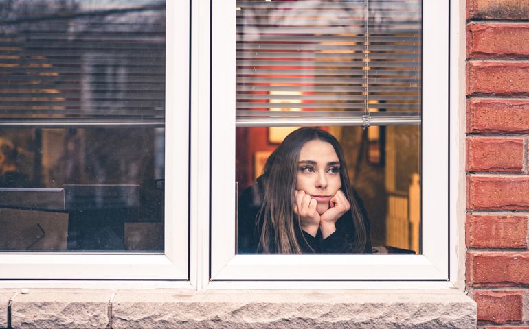 woman looking out window
