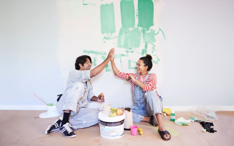 Couple taking break while renovating home