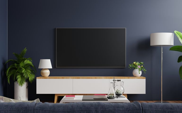 Mockup tv on cabinet in modern empty room with behind the dark blue wall.