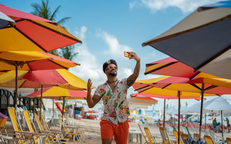 Man vlogging on the beach