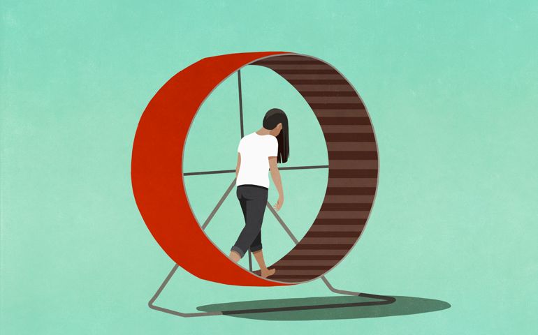 Tired woman walking in hamster wheel