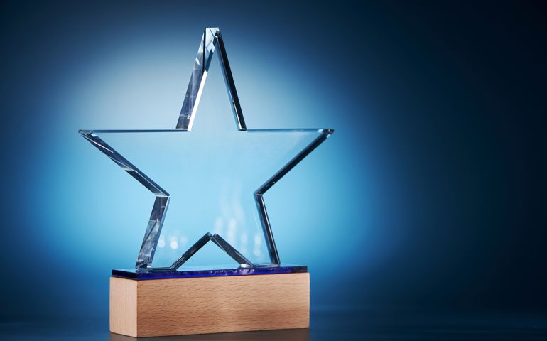 crystal star shape trophy against blue background