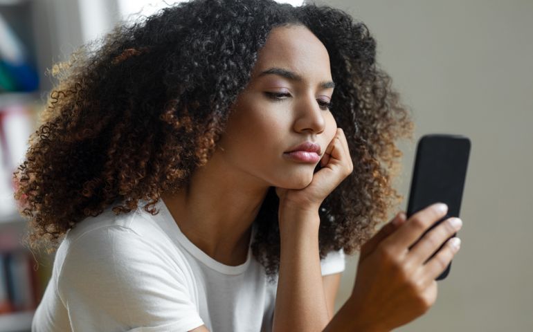 Woman looking at mobile phone screen